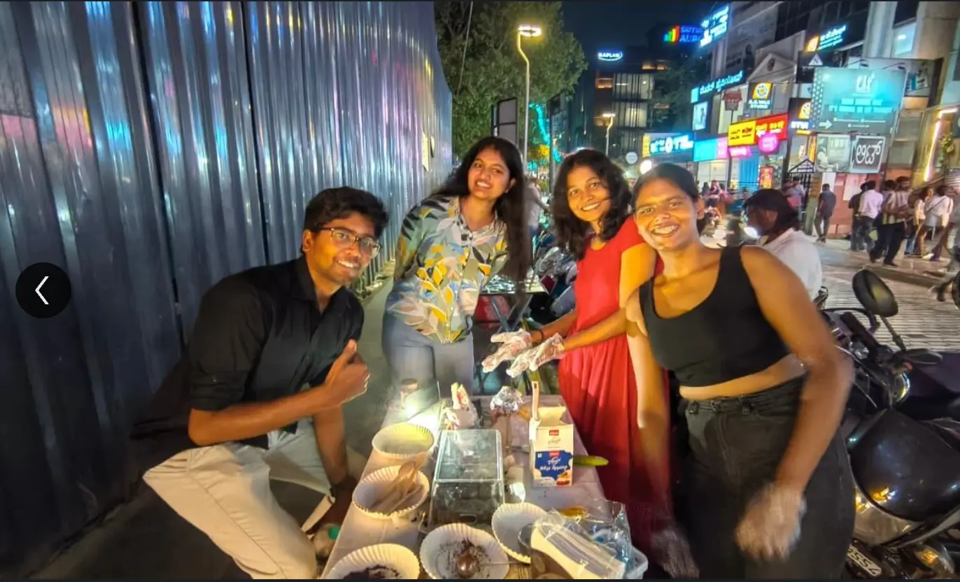 Students running a street food stall at night